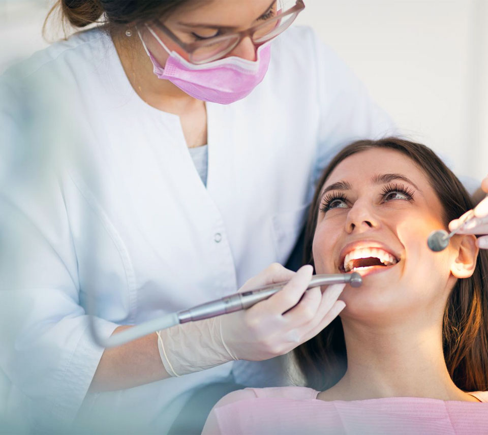 Picture of a lady dentist treating a lady patient