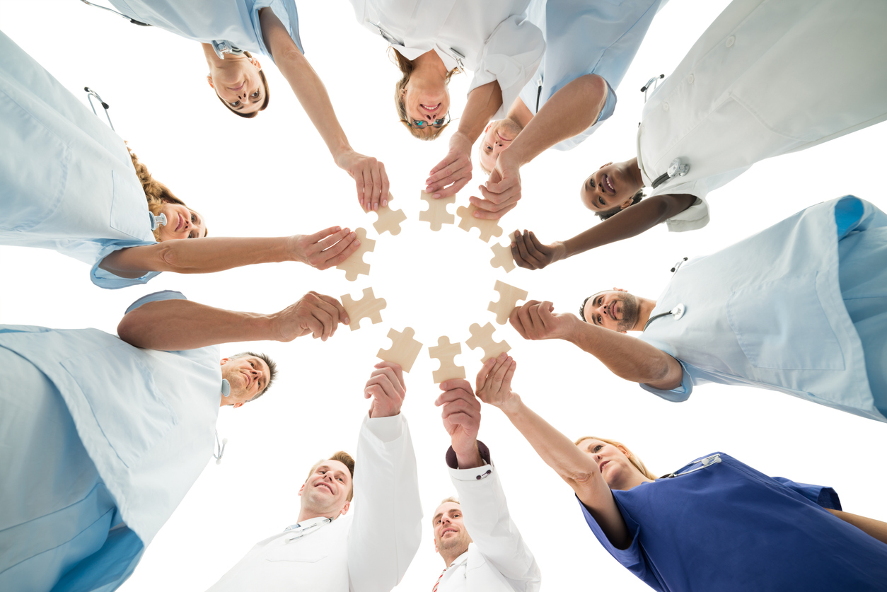 Image of a medical team holding jigsaw puzzles as featured image for "How Do Dentists and Endodontists Differ?"