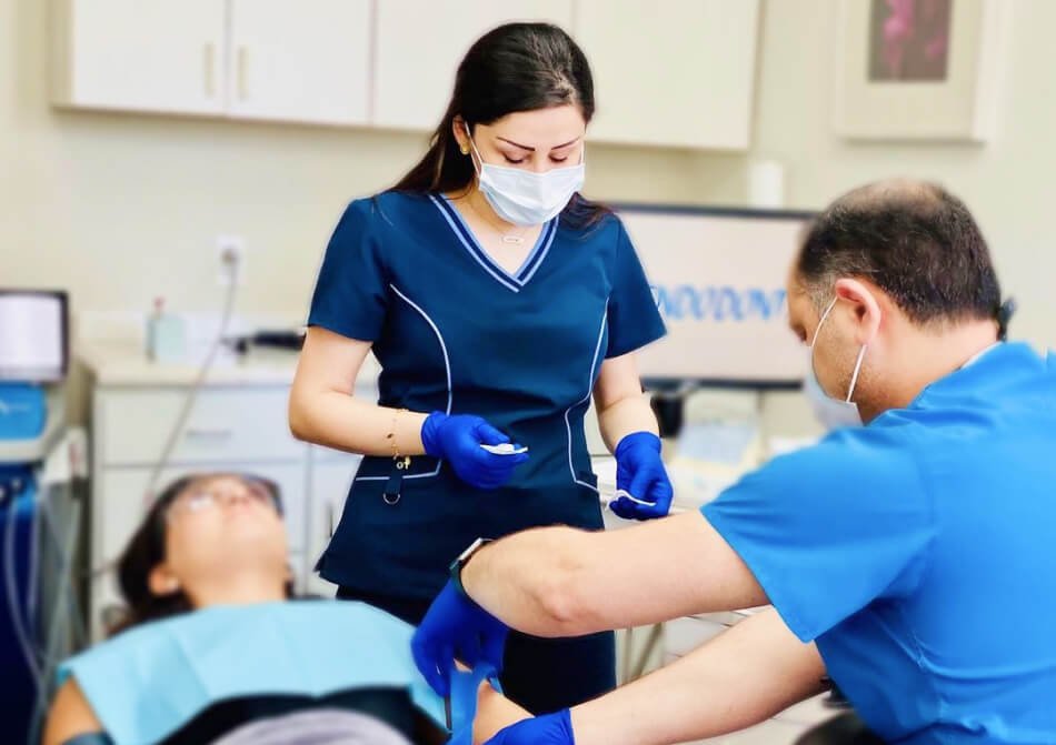 Dr. Maz Ebrahimi and assistant working on a patient in Beverly Hills